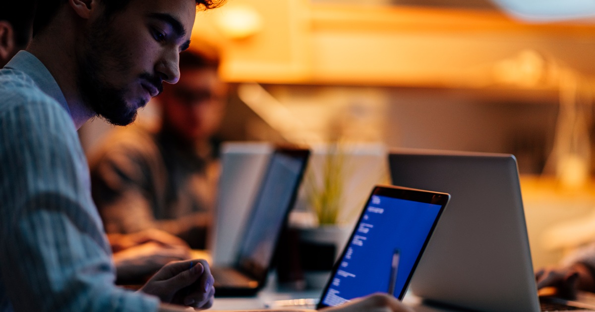 Man working on laptop late night in office