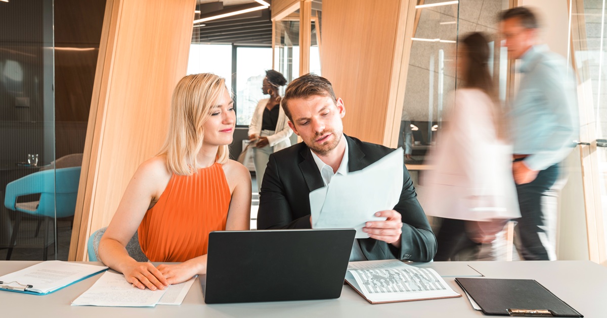 Man and woman reading Big I report on stabilizing insurance market