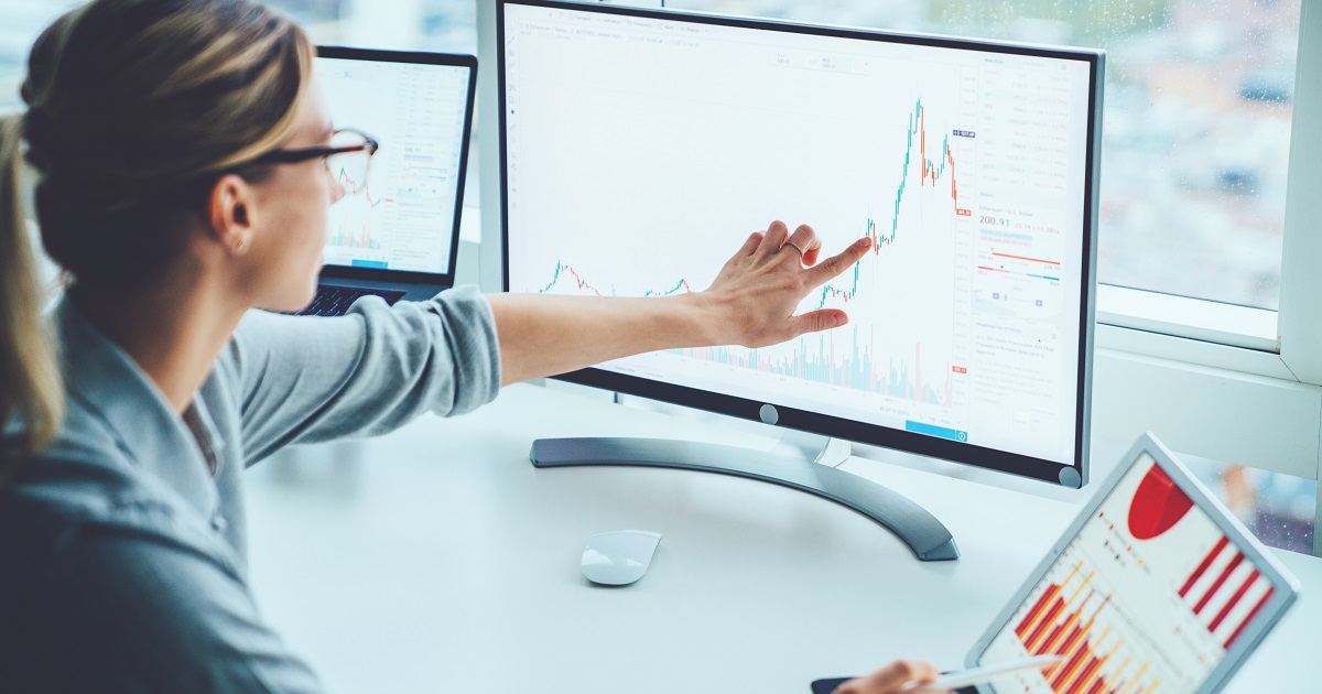 Woman analyzing data on computer screen