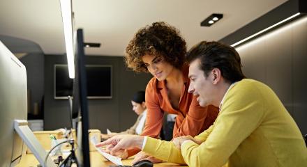man and woman looking at a computer
