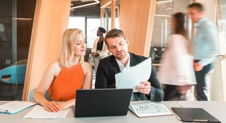Man and woman reading Big I report on stabilizing insurance market