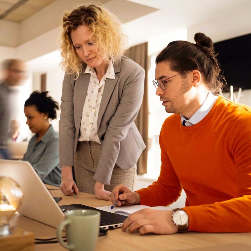 AI platform built for insurance workflows - coworkers looking at laptop