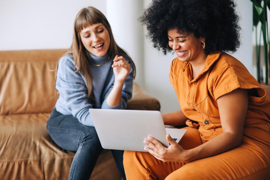 Two people working together on a laptop